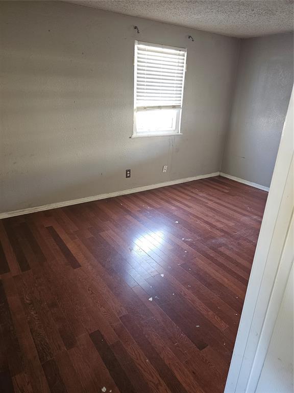1137 Mallard Dr, Del City, OK 73115 - unfurnished room with wood finished floors and a textured ceiling
