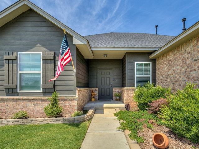 14325 Meadow Ridge Ln, Edmond, OK 73025 - doorway to property featuring brick siding and a shingled roof