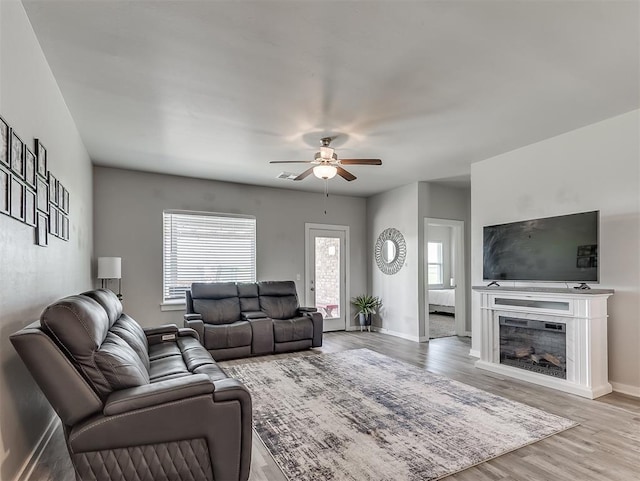 14325 Meadow Ridge Ln, Edmond, OK 73025 - living area with a ceiling fan, wood finished floors, and a fireplace