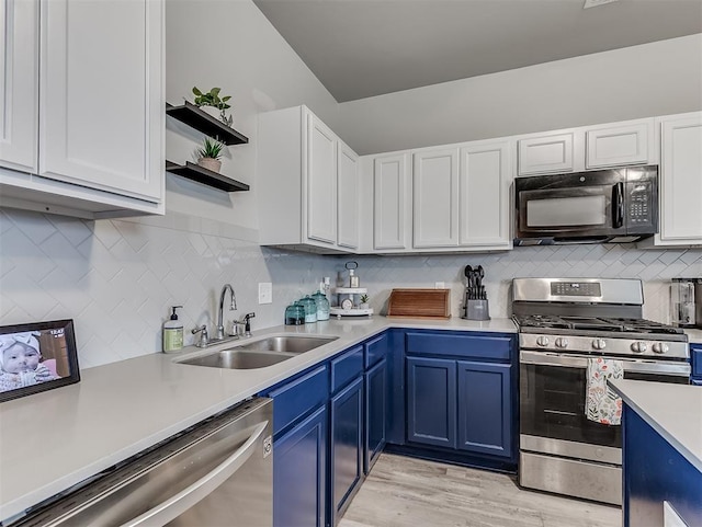 14325 Meadow Ridge Ln, Edmond, OK 73025 - kitchen with appliances with stainless steel finishes, blue cabinets, light countertops, and open shelves