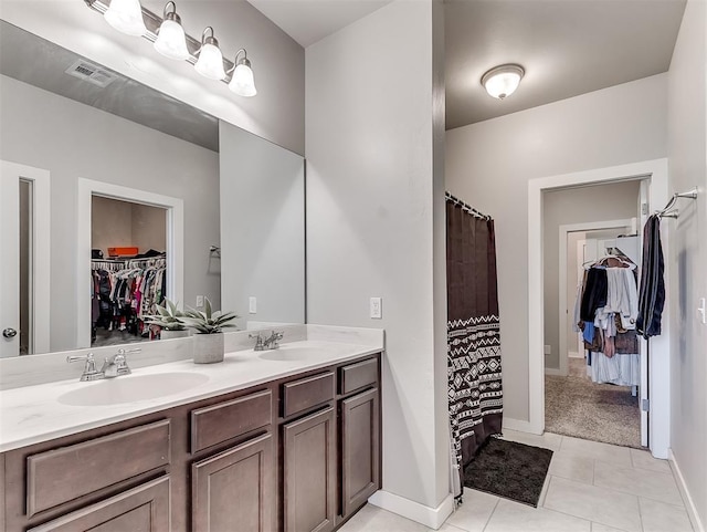 14325 Meadow Ridge Ln, Edmond, OK 73025 - full bath with a walk in closet, double vanity, and tile patterned flooring