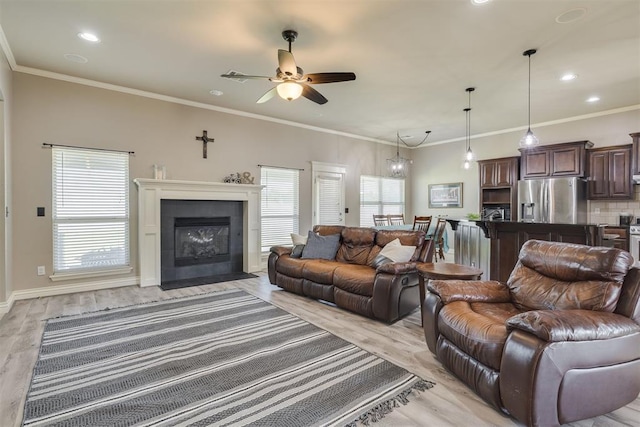 4501 NW 164th Ter, Edmond, OK 73013 - living area with light wood-style flooring, a ceiling fan, plenty of natural light, recessed lighting, and a fireplace with flush hearth