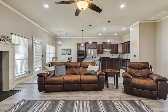 4501 NW 164th Ter, Edmond, OK 73013 - living area featuring light wood-type flooring, ceiling fan, recessed lighting, and crown molding