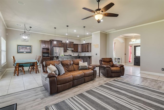 4501 NW 164th Ter, Edmond, OK 73013 - living area with arched walkways, a ceiling fan, light tile patterned flooring, ornamental molding, and recessed lighting