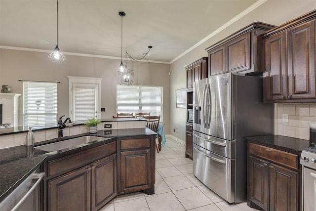 4501 NW 164th Ter, Edmond, OK 73013 - kitchen with stainless steel appliances, light tile patterned floors, decorative backsplash, dark stone countertops, and pendant lighting