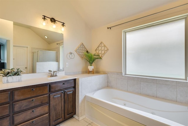 4501 NW 164th Ter, Edmond, OK 73013 - bathroom with lofted ceiling, a jetted tub, vanity, tile patterned flooring, and a stall shower