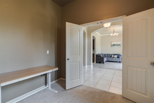 4501 NW 164th Ter, Edmond, OK 73013 - corridor featuring arched walkways, light colored carpet, light tile patterned floors, and a chandelier