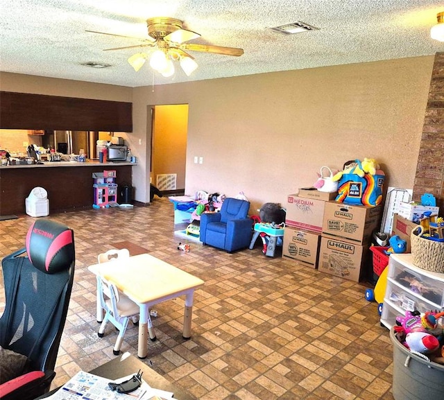 3120 Del Rey Dr, Midwest City, OK 73110 - recreation room with a ceiling fan and brick patterned flooring
