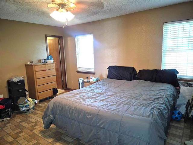 3120 Del Rey Dr, Midwest City, OK 73110 - bedroom with multiple windows, a textured ceiling, and a textured wall