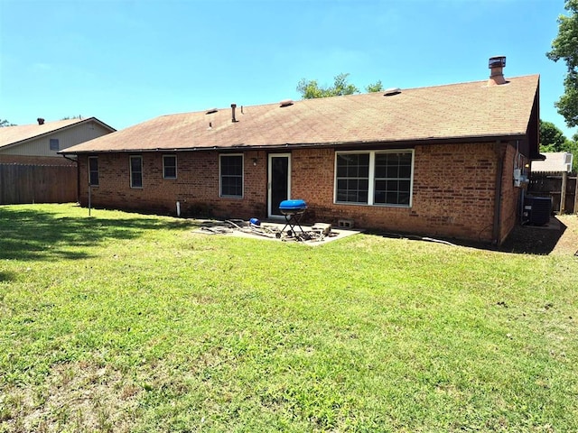 3120 Del Rey Dr, Midwest City, OK 73110 - back of house with a fenced backyard, brick siding, roof with shingles, and a patio