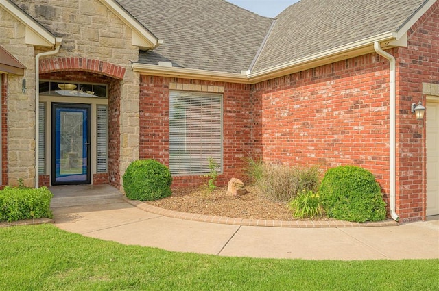 5404 NW 119th St, Oklahoma City, OK 73162 - property entrance featuring roof with shingles, brick siding, a garage, and stone siding