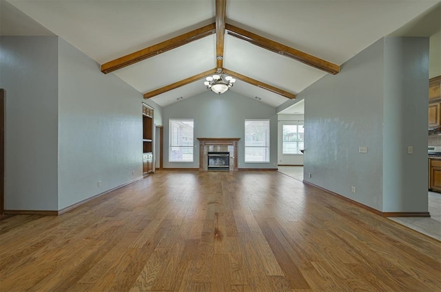 5404 NW 119th St, Oklahoma City, OK 73162 - unfurnished living room with light wood-type flooring, a glass covered fireplace, and a chandelier