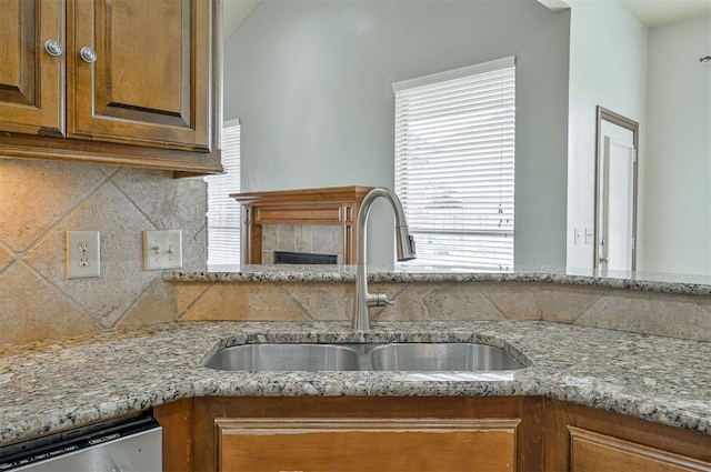 5404 NW 119th St, Oklahoma City, OK 73162 - kitchen with dishwasher, decorative backsplash, light stone countertops, and brown cabinets