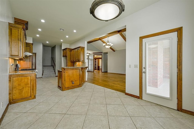 5404 NW 119th St, Oklahoma City, OK 73162 - kitchen with brown cabinets, a peninsula, light tile patterned floors, recessed lighting, and light stone counters