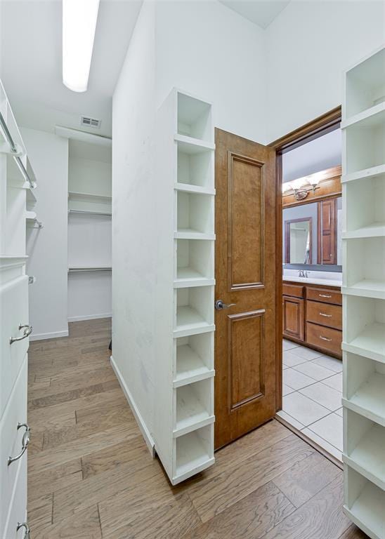 5404 NW 119th St, Oklahoma City, OK 73162 - walk in closet with light wood-style floors and a sink