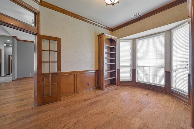 5404 NW 119th St, Oklahoma City, OK 73162 - unfurnished room featuring wood finished floors, plenty of natural light, ornamental molding, and wainscoting