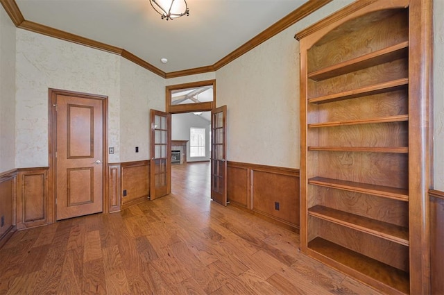 5404 NW 119th St, Oklahoma City, OK 73162 - hallway with crown molding, a wainscoted wall, and wood finished floors