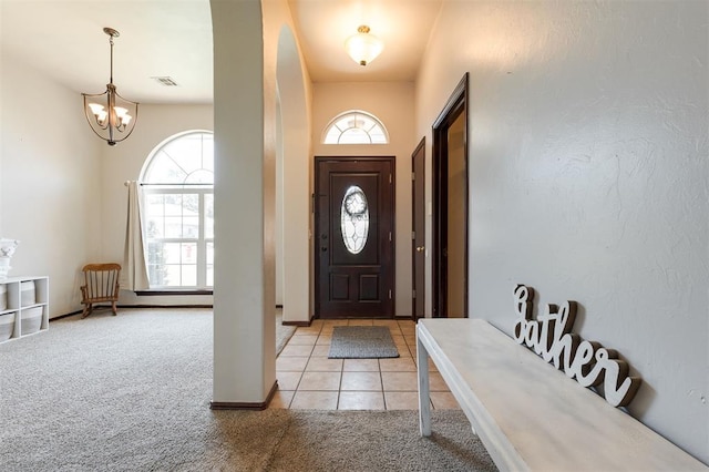 2001 Fair Meadow Dr, Edmond, OK 73003 - entrance foyer with light colored carpet, plenty of natural light, a chandelier, and light tile patterned floors