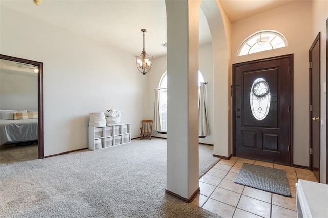 2001 Fair Meadow Dr, Edmond, OK 73003 - foyer with arched walkways, a chandelier, and light colored carpet