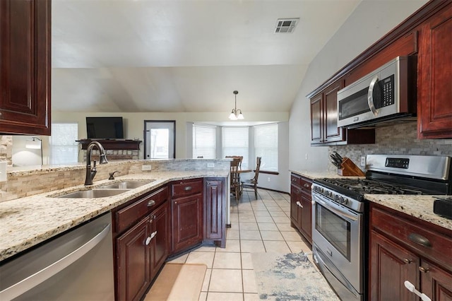 2001 Fair Meadow Dr, Edmond, OK 73003 - kitchen featuring stainless steel appliances, lofted ceiling, tasteful backsplash, light tile patterned flooring, and dark brown cabinets