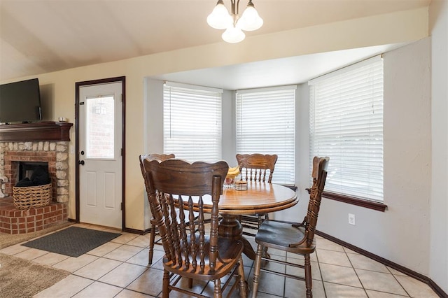 2001 Fair Meadow Dr, Edmond, OK 73003 - dining area featuring light tile patterned flooring, a chandelier, and a fireplace