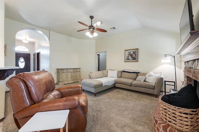 2001 Fair Meadow Dr, Edmond, OK 73003 - carpeted living area with ceiling fan, lofted ceiling, a fireplace, and arched walkways