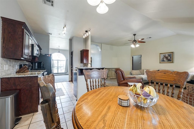 2001 Fair Meadow Dr, Edmond, OK 73003 - dining space with light tile patterned floors, a ceiling fan, and lofted ceiling
