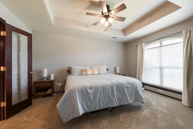 2001 Fair Meadow Dr, Edmond, OK 73003 - carpeted bedroom with a raised ceiling and ceiling fan