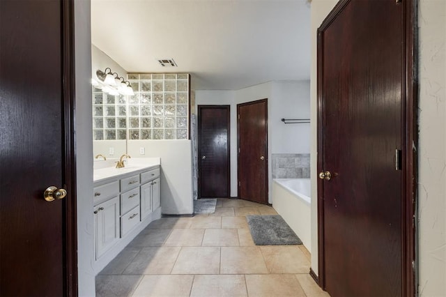 2001 Fair Meadow Dr, Edmond, OK 73003 - bathroom featuring vanity, a bath, and tile patterned floors
