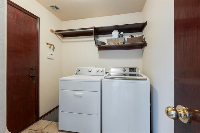 2001 Fair Meadow Dr, Edmond, OK 73003 - laundry area featuring washing machine and dryer and light tile patterned floors