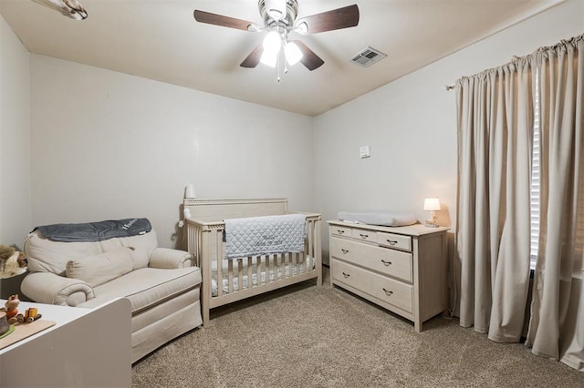 2001 Fair Meadow Dr, Edmond, OK 73003 - bedroom with light colored carpet, a nursery area, and ceiling fan