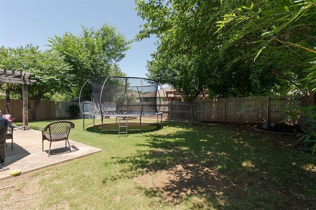 2001 Fair Meadow Dr, Edmond, OK 73003 - fenced backyard featuring a trampoline and a patio area