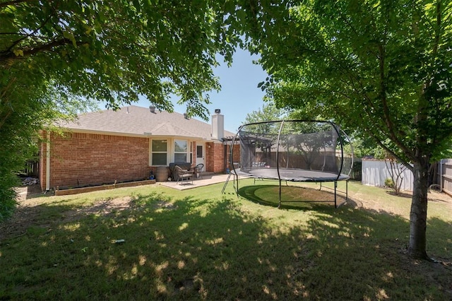 2001 Fair Meadow Dr, Edmond, OK 73003 - fenced backyard with a trampoline and a patio