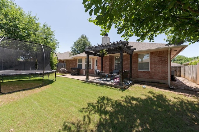 2001 Fair Meadow Dr, Edmond, OK 73003 - back of property with a trampoline, a pergola, a chimney, a fenced backyard, and brick siding