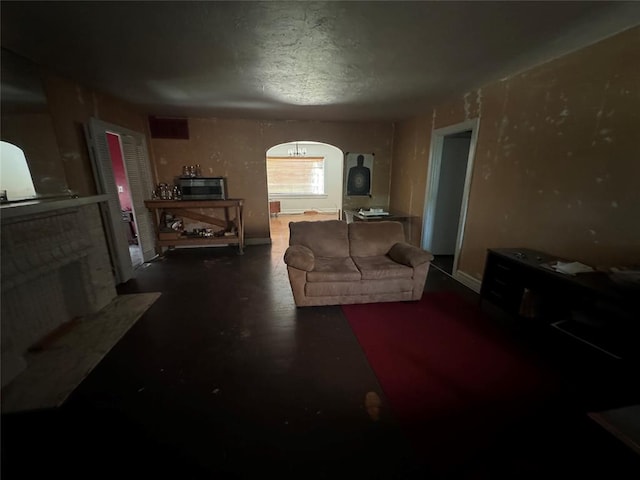 2701 NW 12th St, Oklahoma City, OK 73107 - living room with a fireplace, finished concrete floors, and arched walkways