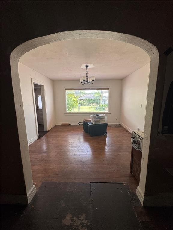 2701 NW 12th St, Oklahoma City, OK 73107 - hallway featuring arched walkways, a chandelier, and wood finished floors