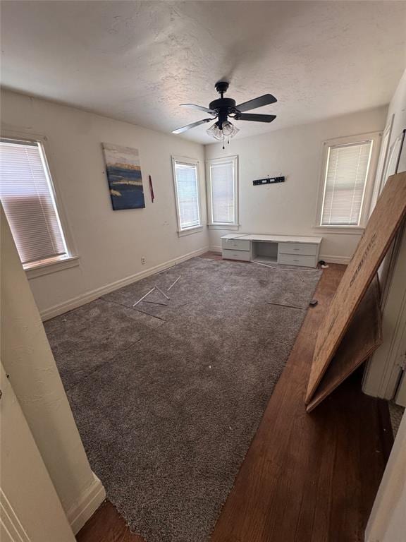 2701 NW 12th St, Oklahoma City, OK 73107 - unfurnished living room featuring ceiling fan and a textured ceiling