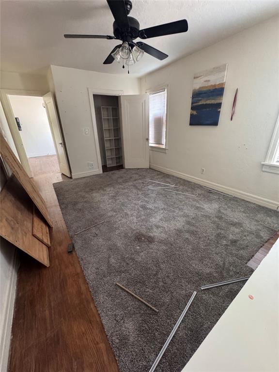 2701 NW 12th St, Oklahoma City, OK 73107 - unfurnished bedroom with baseboards and a ceiling fan