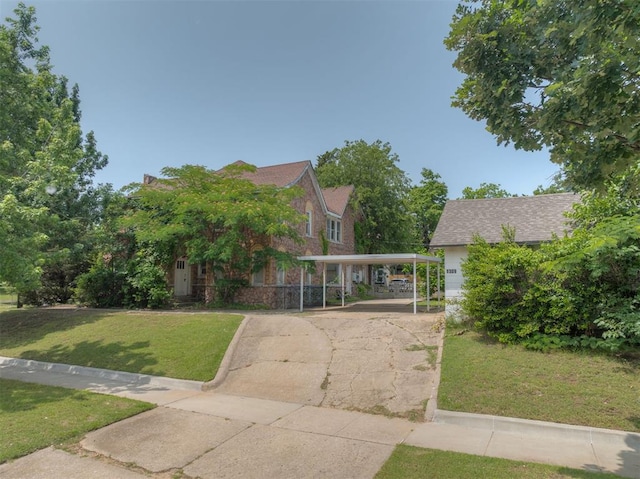 2701 NW 12th St, Oklahoma City, OK 73107 - view of front of home with a carport, a front lawn, and concrete driveway