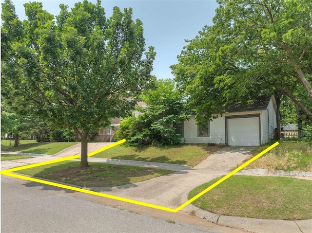 2701 NW 12th St, Oklahoma City, OK 73107 - obstructed view of property featuring a front lawn and driveway