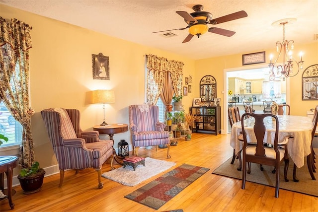 828 N Pine St, Pauls Valley, OK 73075 - dining area featuring wood-type flooring, ceiling fan, and a chandelier