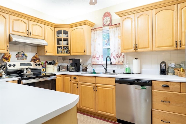 828 N Pine St, Pauls Valley, OK 73075 - kitchen featuring stainless steel appliances, under cabinet range hood, light brown cabinetry, decorative backsplash, and light countertops