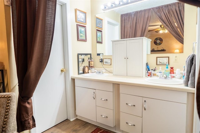 828 N Pine St, Pauls Valley, OK 73075 - full bath with double vanity, wood finished floors, and ceiling fan