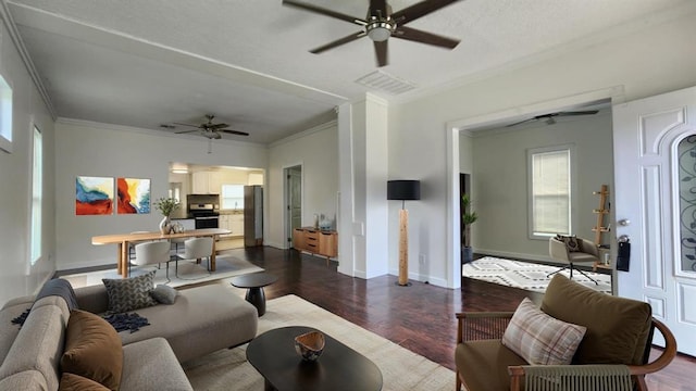 1401 W College Ave, Guthrie, OK 73044 - living area with a ceiling fan, crown molding, and dark wood-type flooring