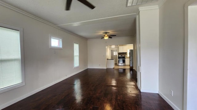 1401 W College Ave, Guthrie, OK 73044 - unfurnished living room featuring a ceiling fan, dark wood-style floors, and ornamental molding
