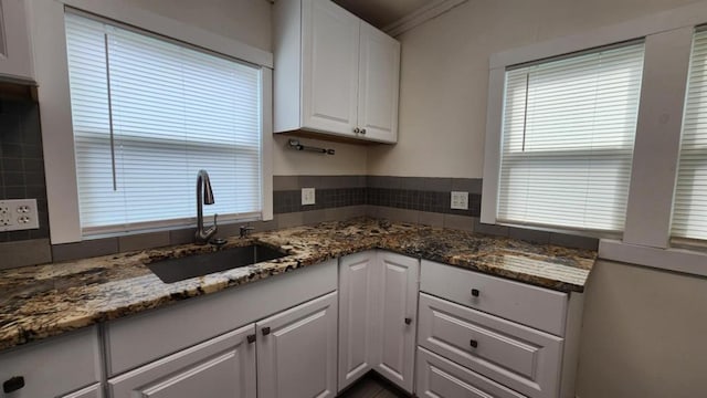 1401 W College Ave, Guthrie, OK 73044 - kitchen featuring white cabinetry, dark stone countertops, and ornamental molding