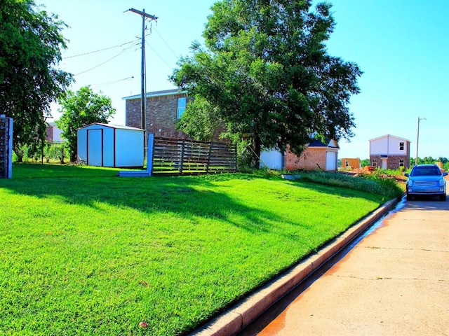 2605 N Kate Ave, Oklahoma City, OK 73111 - view of green lawn featuring a storage unit and concrete driveway