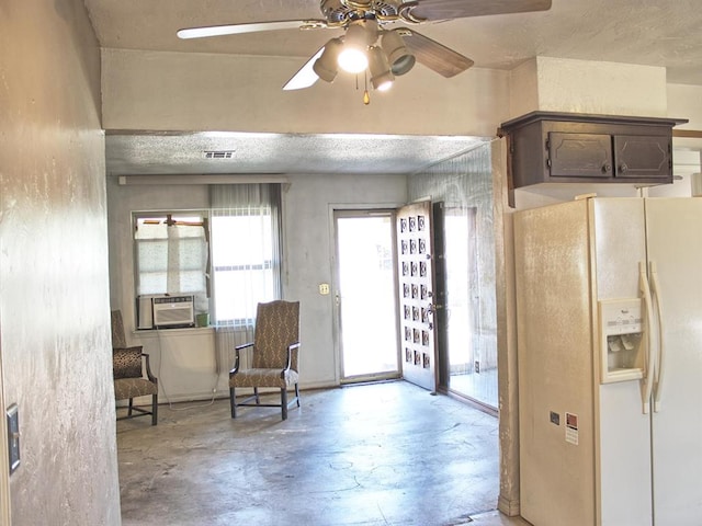 2605 N Kate Ave, Oklahoma City, OK 73111 - living area with concrete floors, ceiling fan, and cooling unit