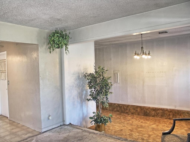 2605 N Kate Ave, Oklahoma City, OK 73111 - unfurnished dining area with a chandelier and a textured ceiling