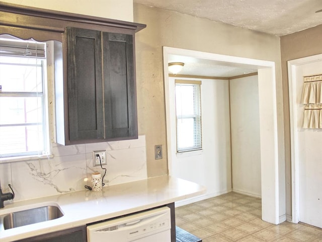2605 N Kate Ave, Oklahoma City, OK 73111 - kitchen with dishwasher, light floors, light countertops, a textured ceiling, and dark brown cabinetry